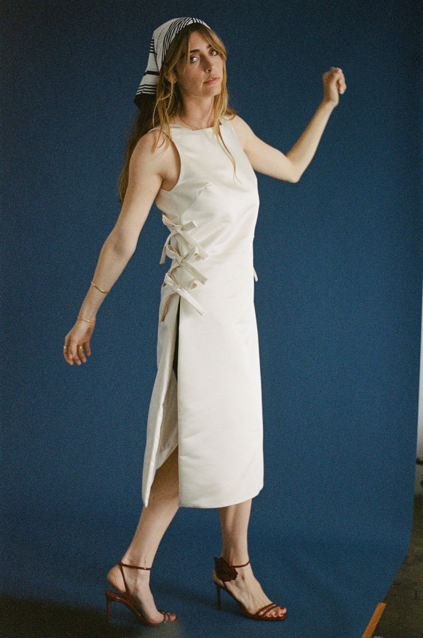 woman in white wedding dress with ties on the side