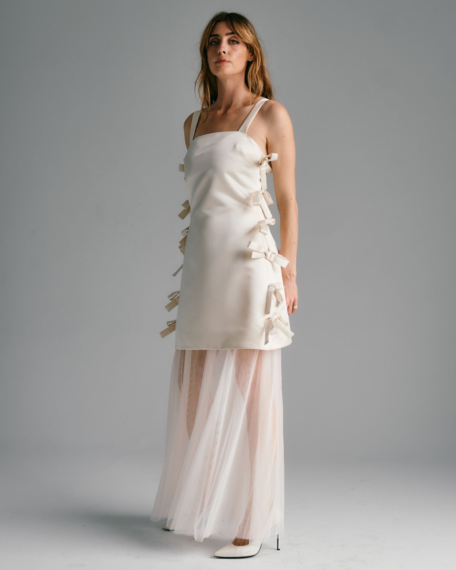 woman in white wedding dress ties down the sides