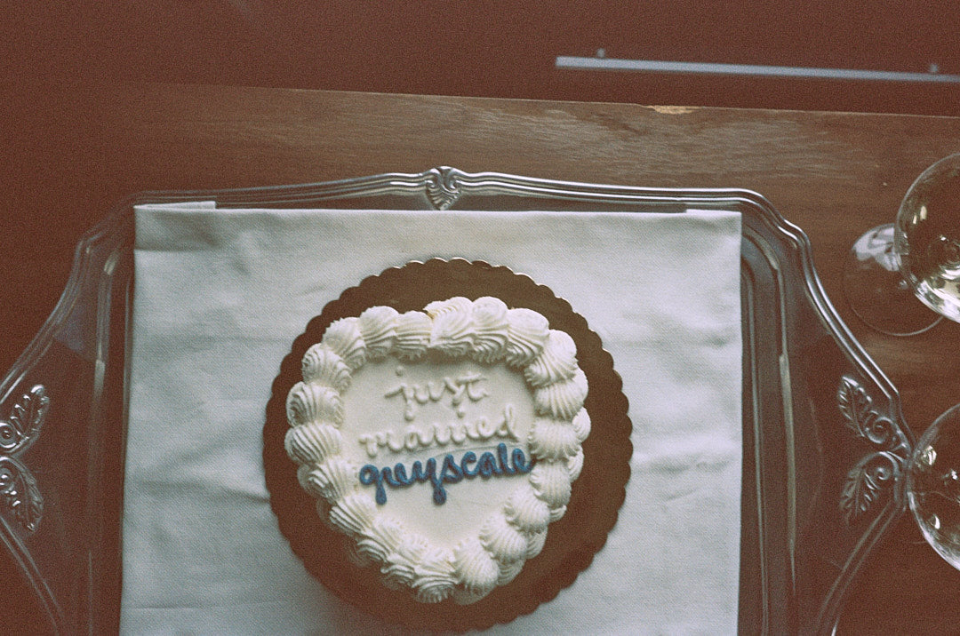top view of just married cake on glass platter