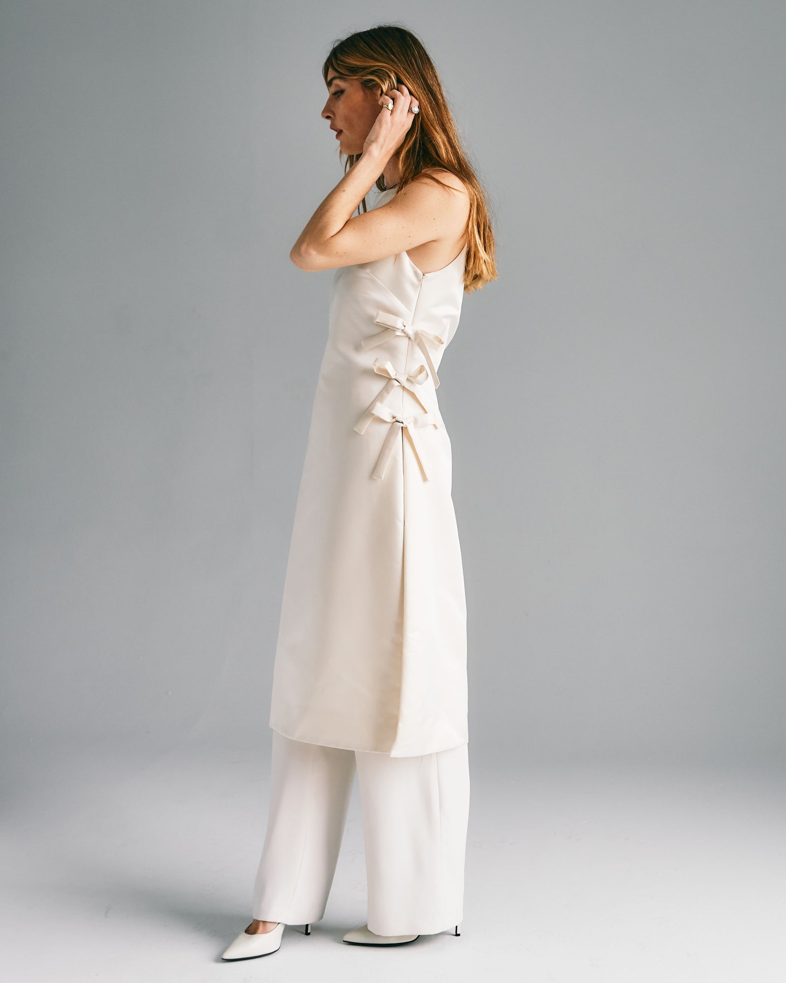 woman in white wedding dress ties on the side