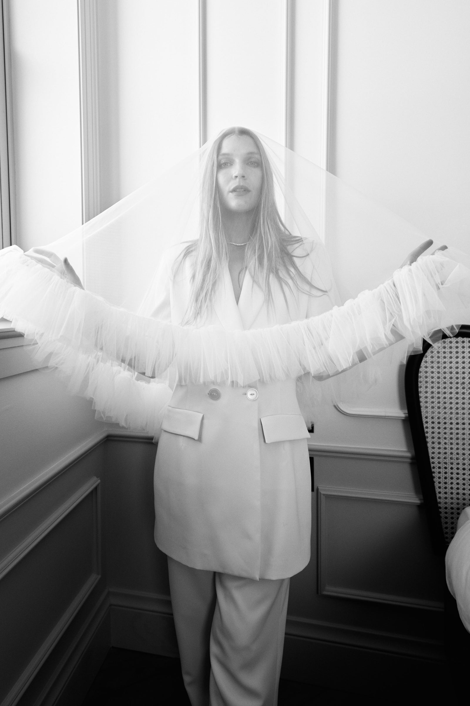 woman in white veil by the window