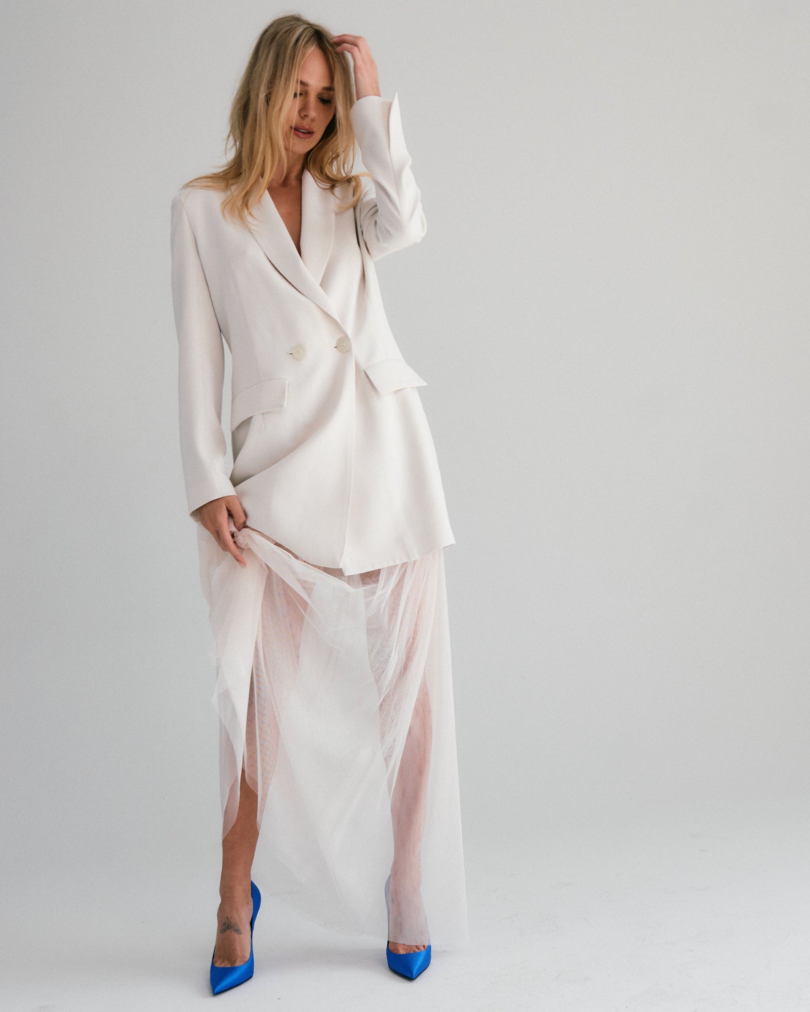 woman in white wedding dress with white blazer