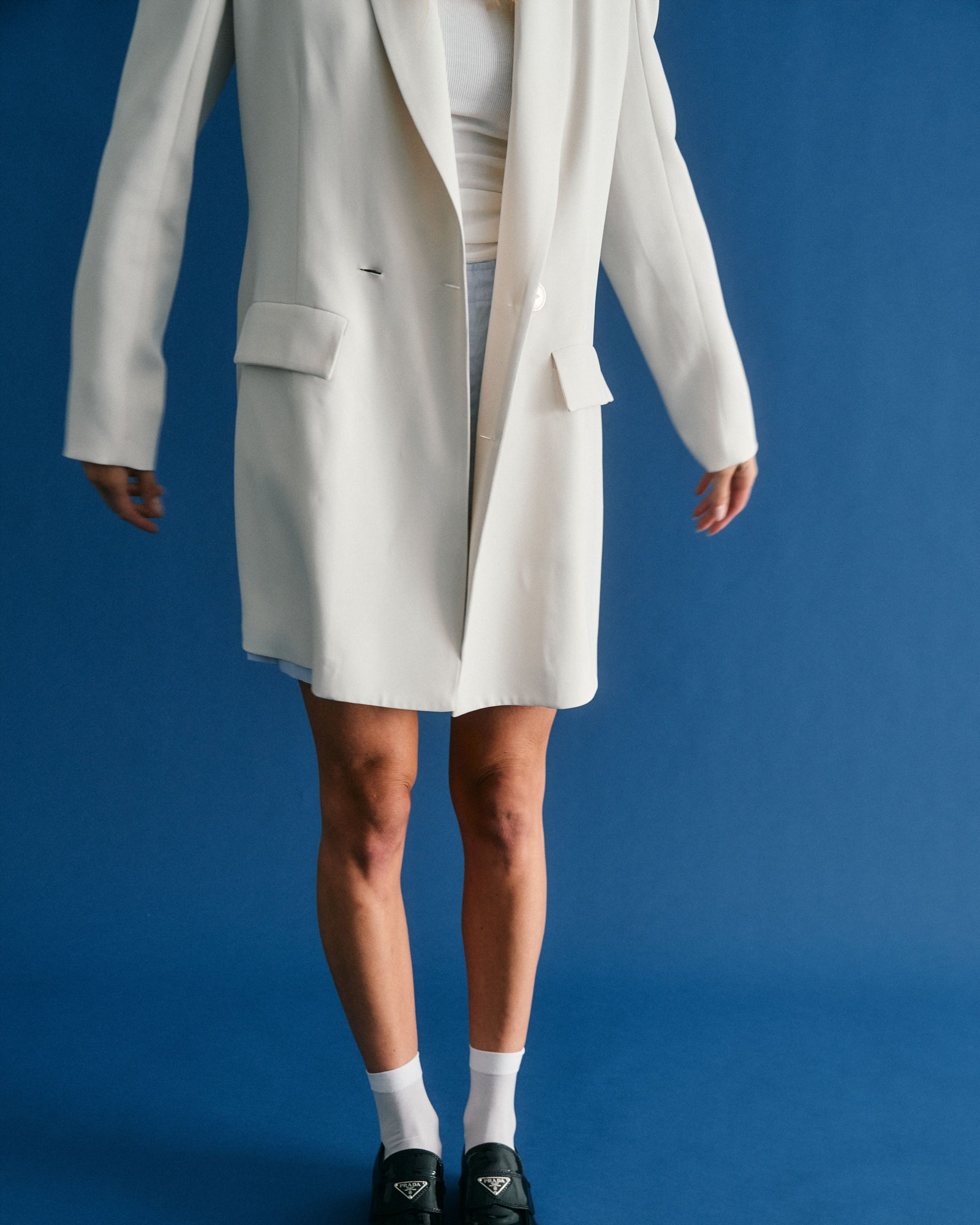 torso of woman in oversized white blazer