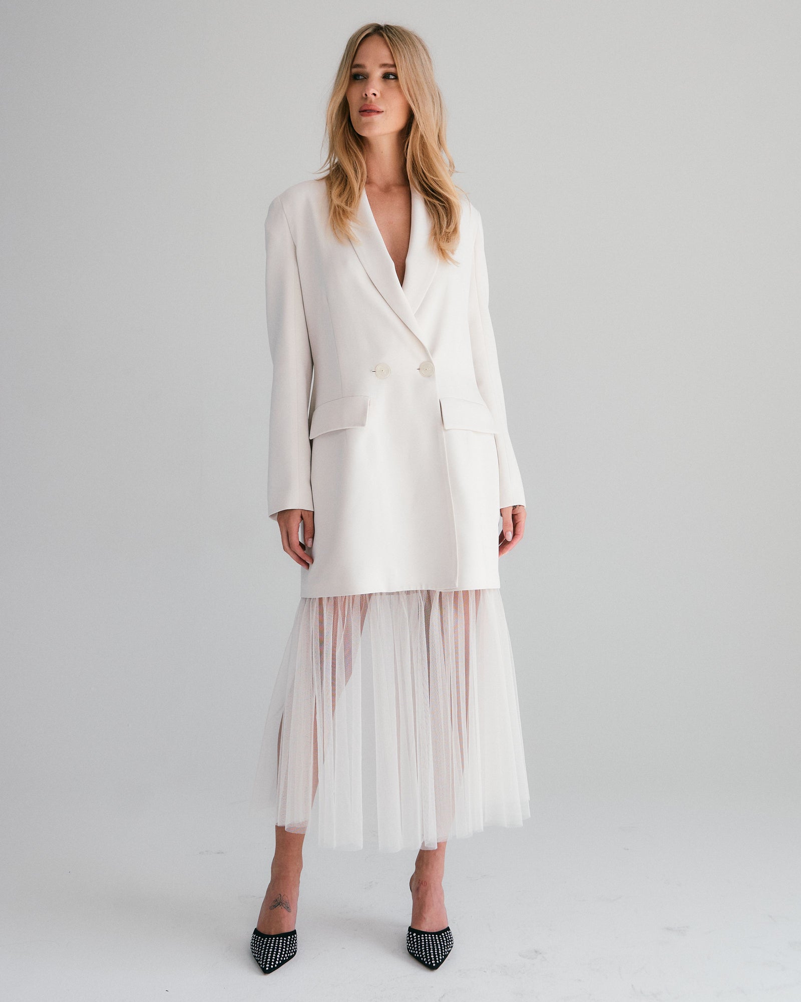 woman in white wedding dress and oversized blazer